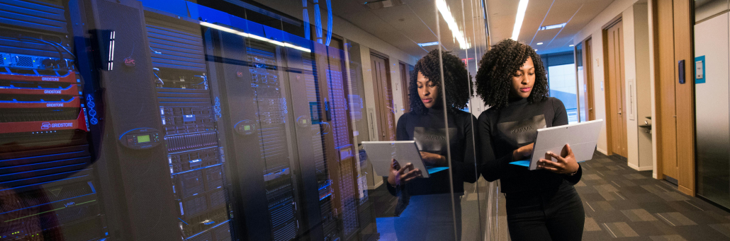 woman standing next to Data center - Fireline Broadband