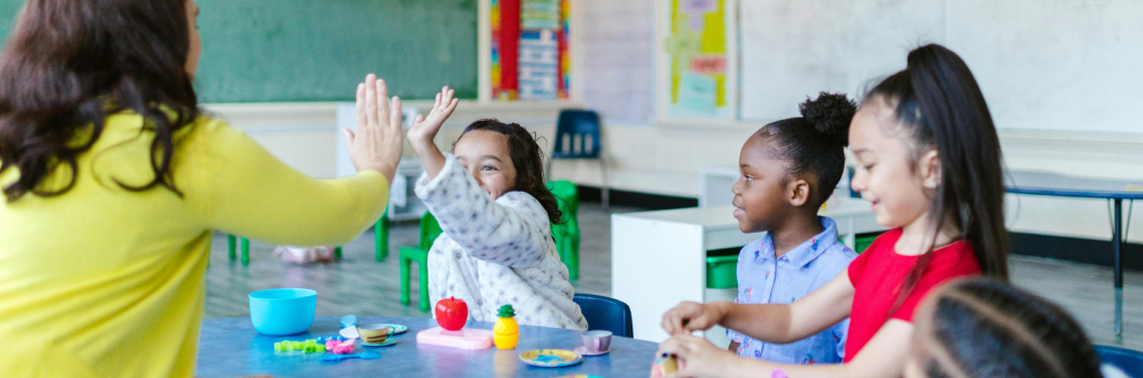 teacher high fiving students in elementary school - Fireline Broadband