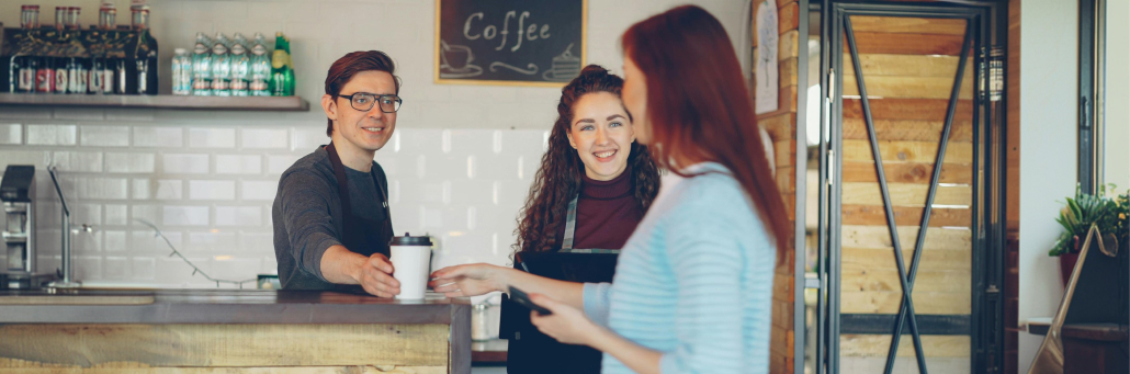 customer placing order at POS at coffee shop - Internet for POS by Fireline Broadband