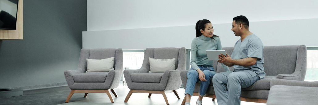 Medical Personnel talking to patient about results using tablet - Fireline Broadband