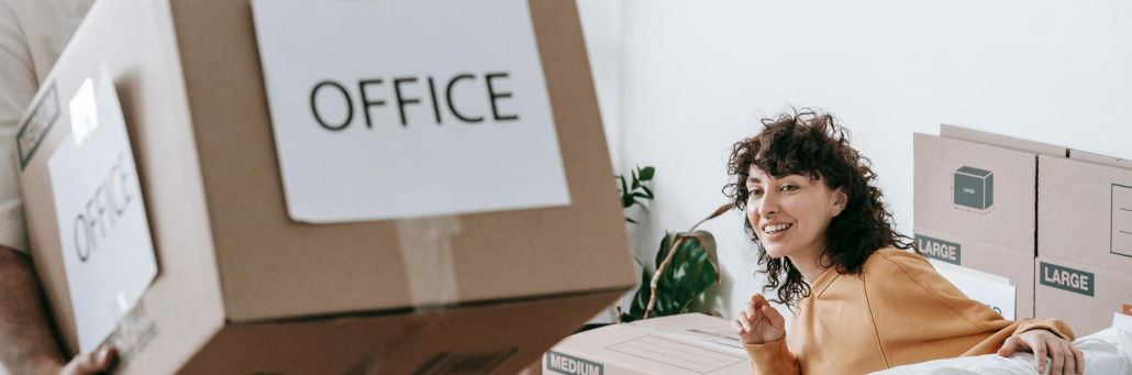 mover moving boxes while lady looks over - Moving Internet with Fireline Broadband