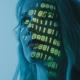 lines of code projected onto woman's face - AI in Cybersecurity - Fireline Broadband