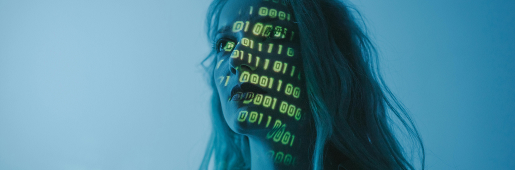 lines of code projected onto woman's face - AI in Cybersecurity - Fireline Broadband