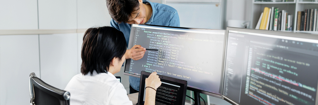 two people working on code - AI cybersecurity Fireline Broadband