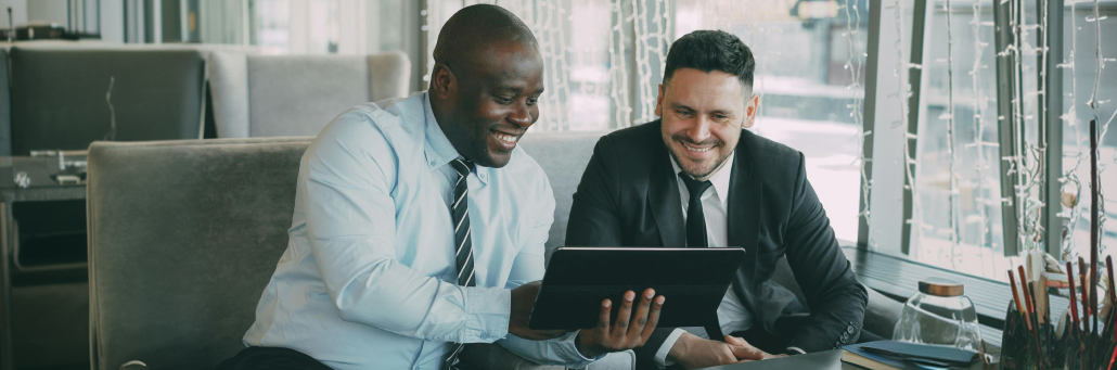 two coworkers looking at laptop screen - AI to fight spam - Fireline Broadband